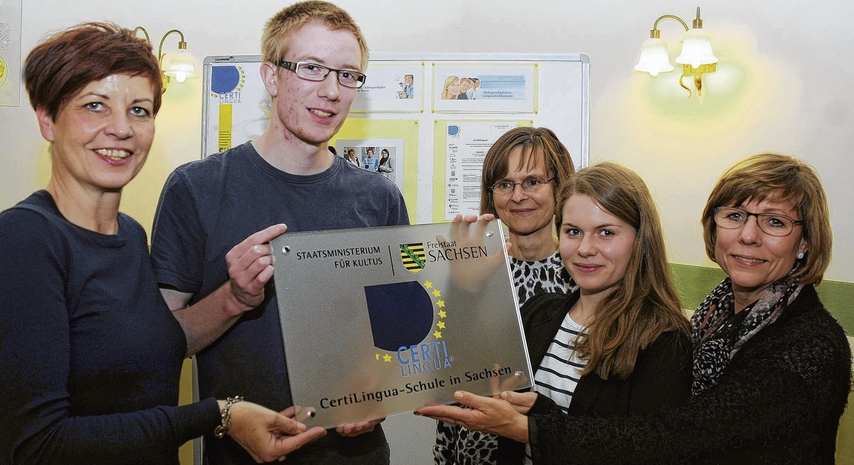 Die Lehrerinnen Heike Kolberg (l.) und Andrea Pospiech (M.), die Schüler Diana Voigtländer und Tom Böhmer sowie Schulleiterin Marion Müller (r.) zeigen die Certi-Lingua-Tafel. Foto:Dirk Hunger